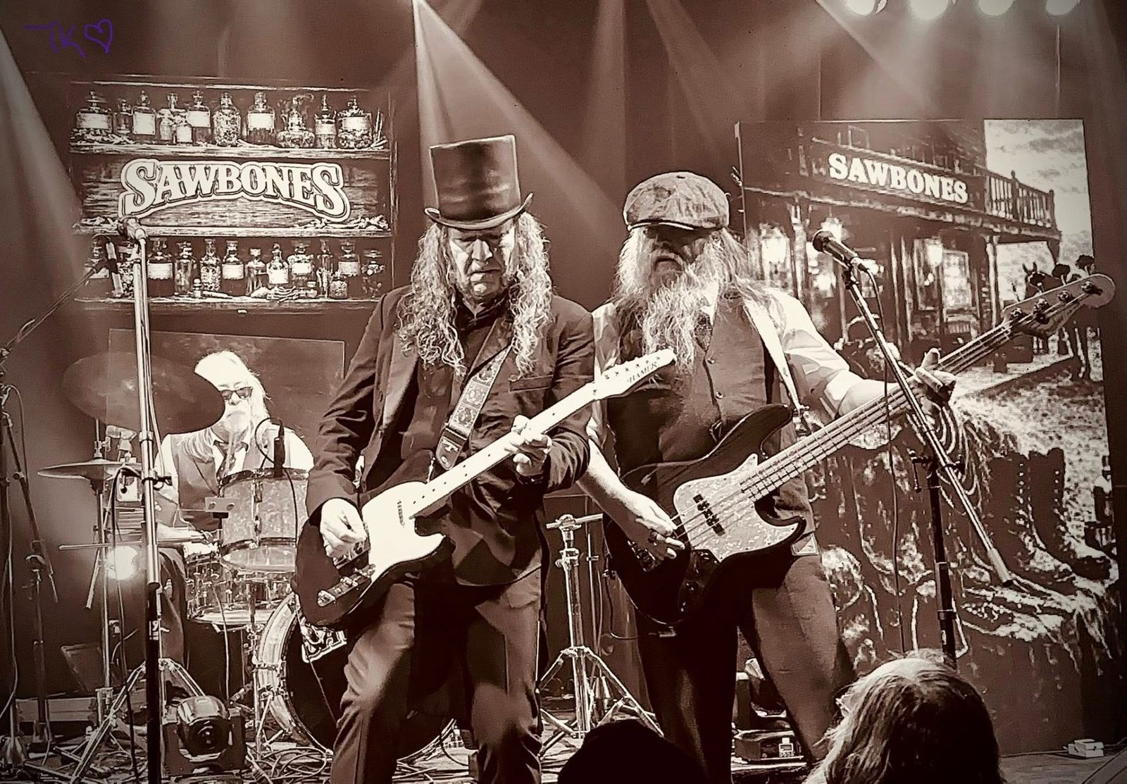 Sawbones performing live in vintage stage attire before a crowd